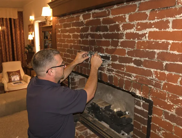 Alafaya Chimney Sweep expert fixing a fireplace in Alafaya, FL